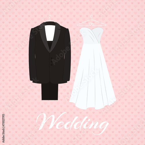 Suit beside wedding dress on pink background