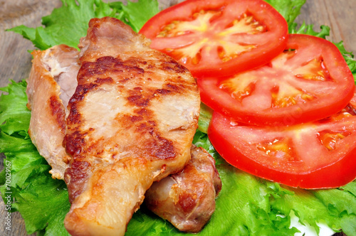 meat chops with tomatoes in a bowl