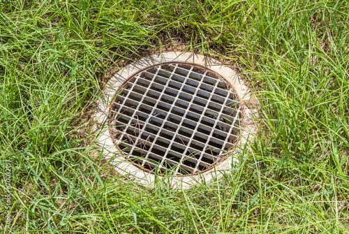 The steel floor drain, running water from the meadow