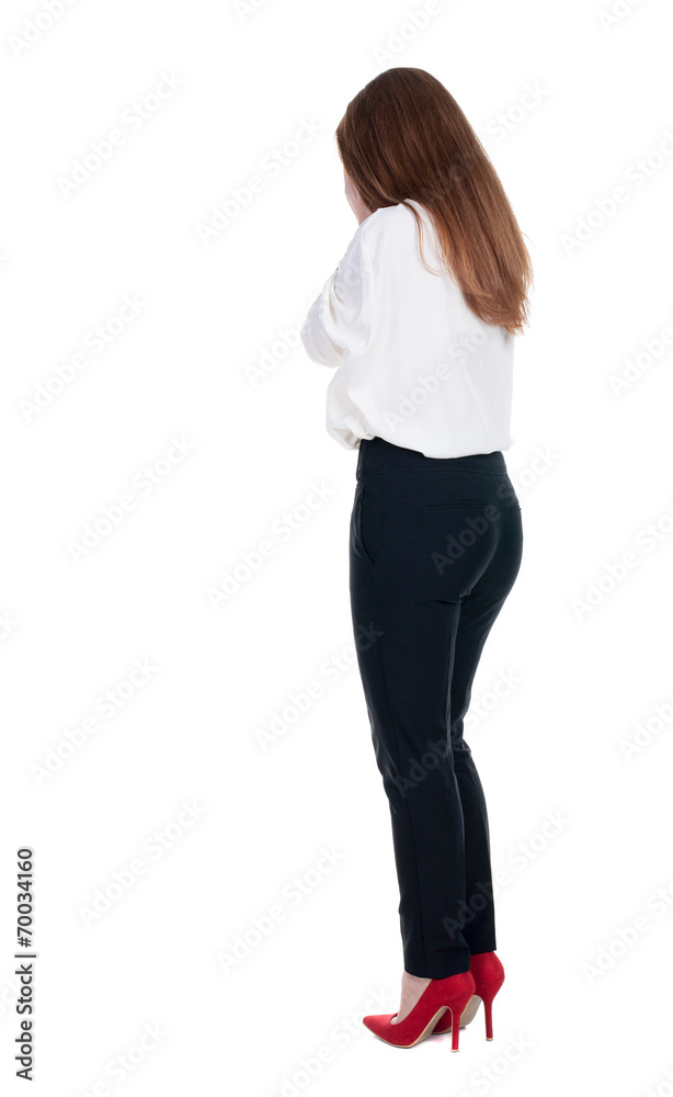Back view of shocked woman in trousers.