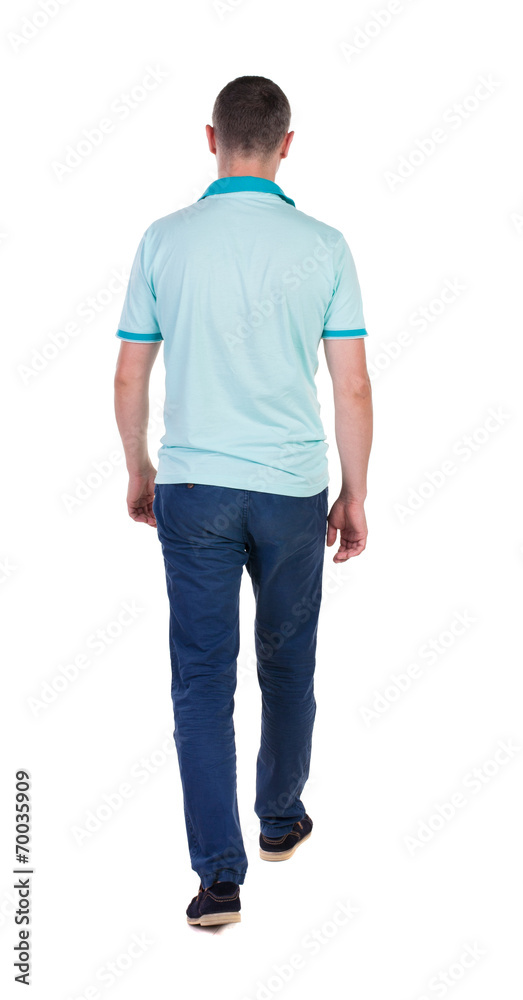 Back view of going handsome man in jeans and a shirt. Back view of going handsome man in jeans and a shirt.