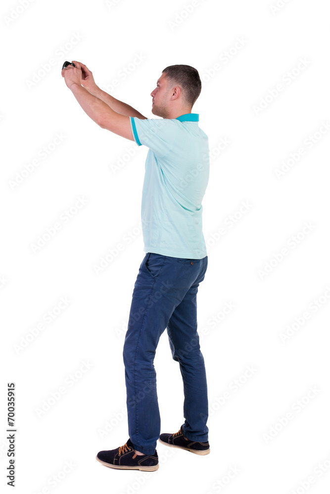 Back view of man photographing. tourist with camera. Back view of man photographing. tourist with camera.