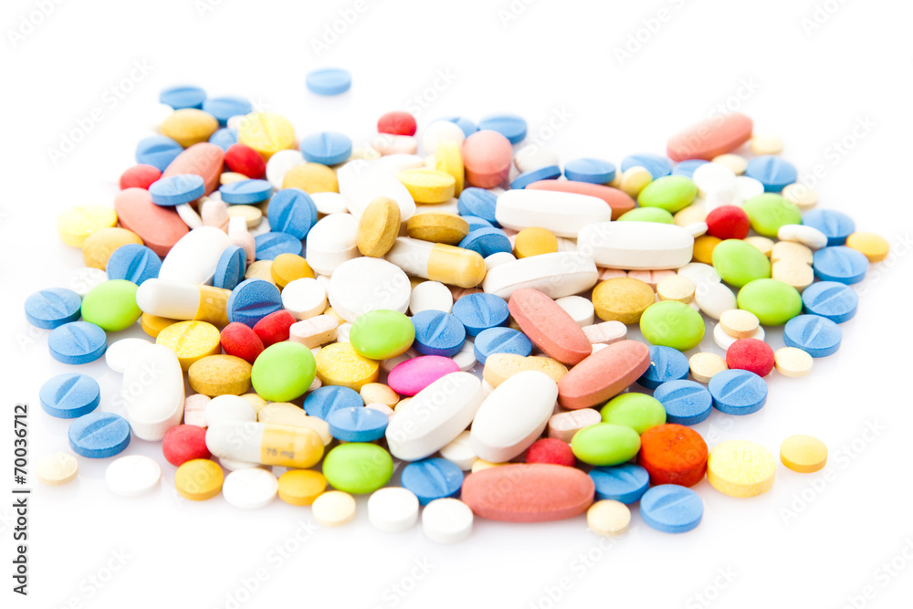 Pile of various colorful pills isolated on white Pile of various colorful pills isolated on white