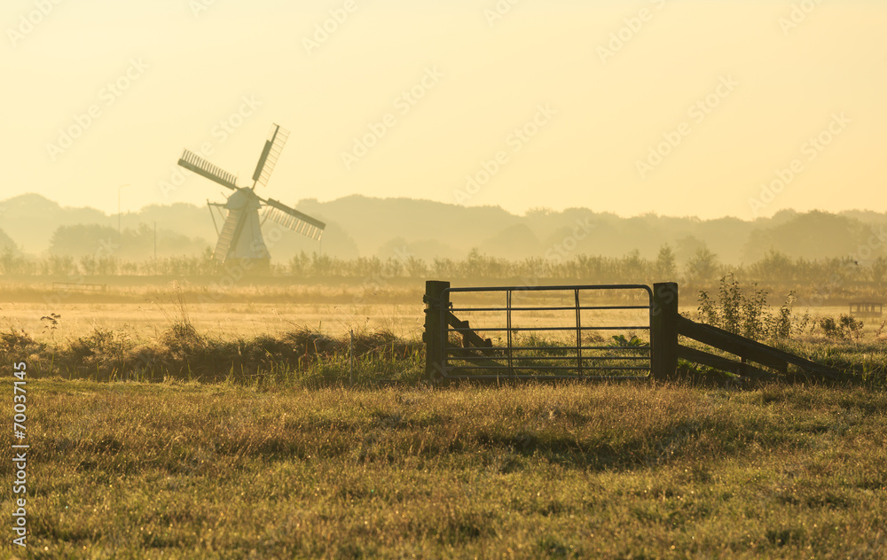 Fototapeta premium Fence and windmill in the Dutch countryside.