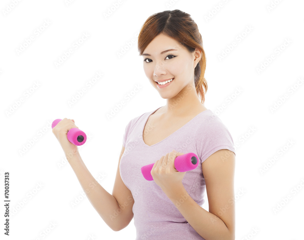 Young woman working out with dumbbells in her hands Young woman working out with dumbbells in her hands