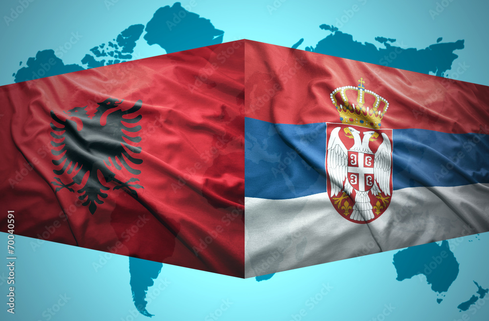 Waving Albanian and Serbian flags