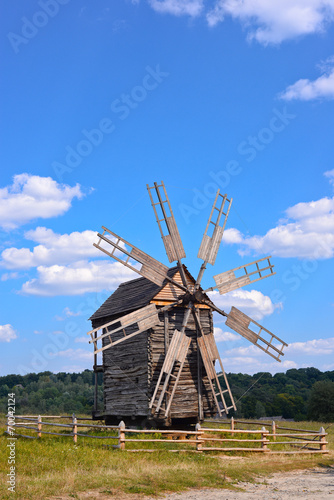 Old wooden windmill on background of blue sky, Kyiv region
