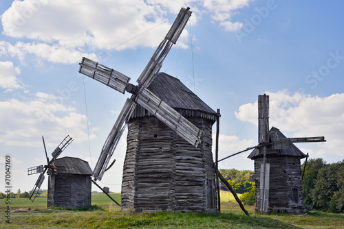 Old wooden windmills on background of blue sky, Kyiv region