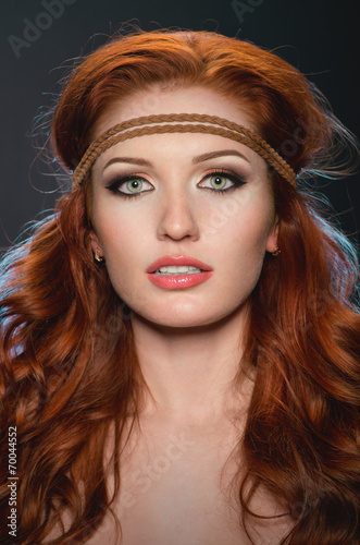 Studio portrait of pretty redhead woman