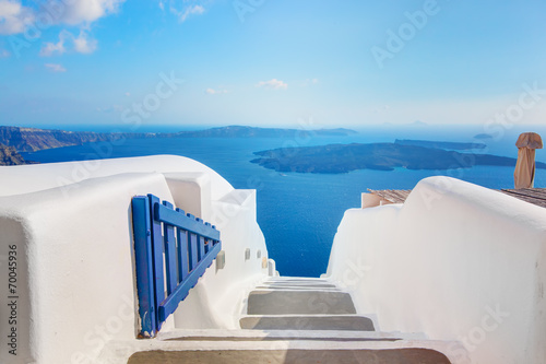 Santorini, Greece. Open blue door. Aegean sea view and Caldera