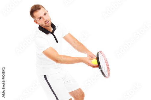 Handsome tennis player serving a ball © Kalim