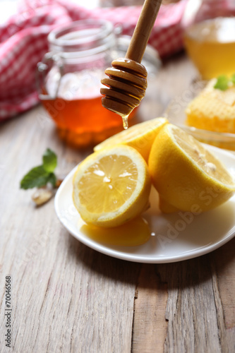 Lemon and honey on wooden table