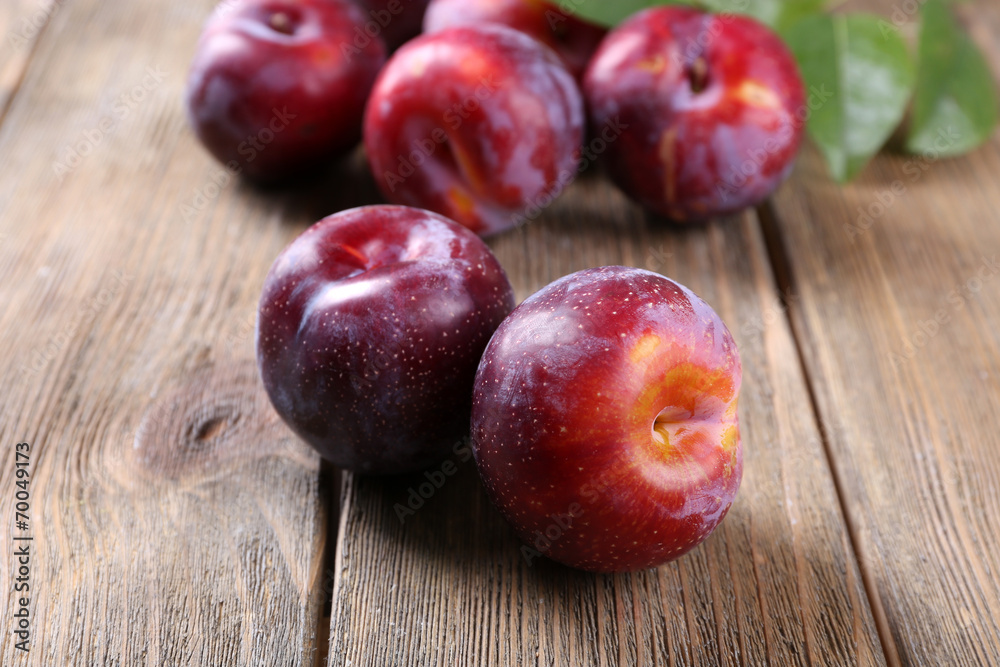 Sweet plums on wooden background