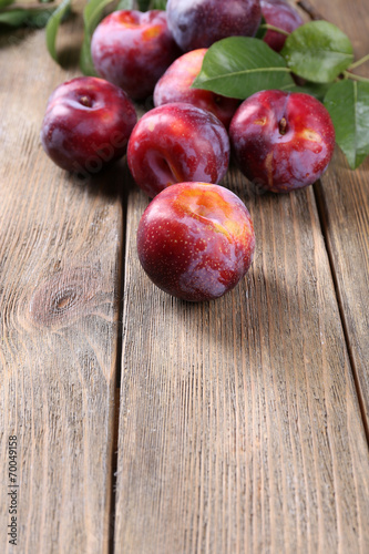 Sweet plums on wooden background