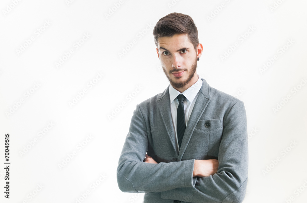 Young serious business man with raised eyebrow and arms crossed Young serious business man with raised eyebrow and arms crossed