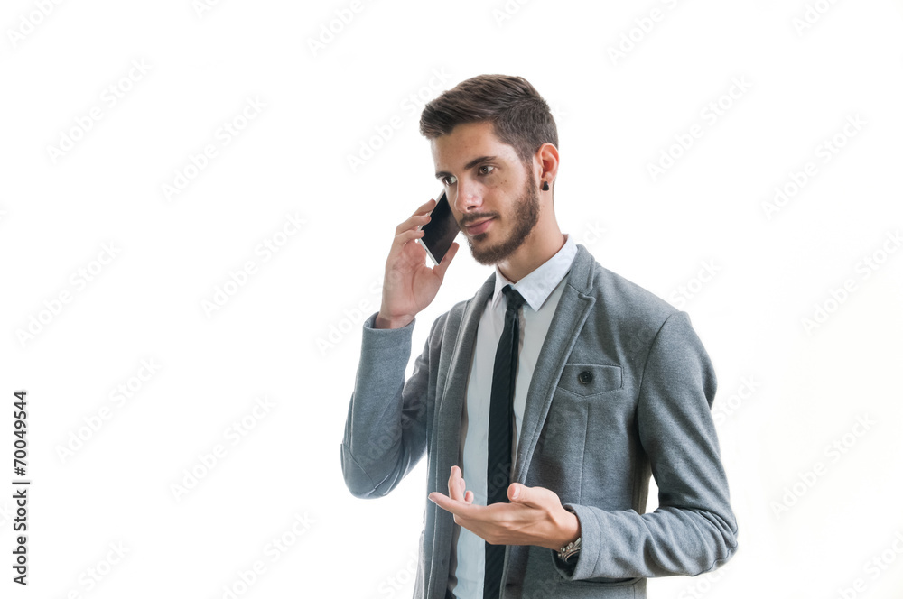 Young successful business man talking on the phone isolated Young successful business man talking on the phone isolated