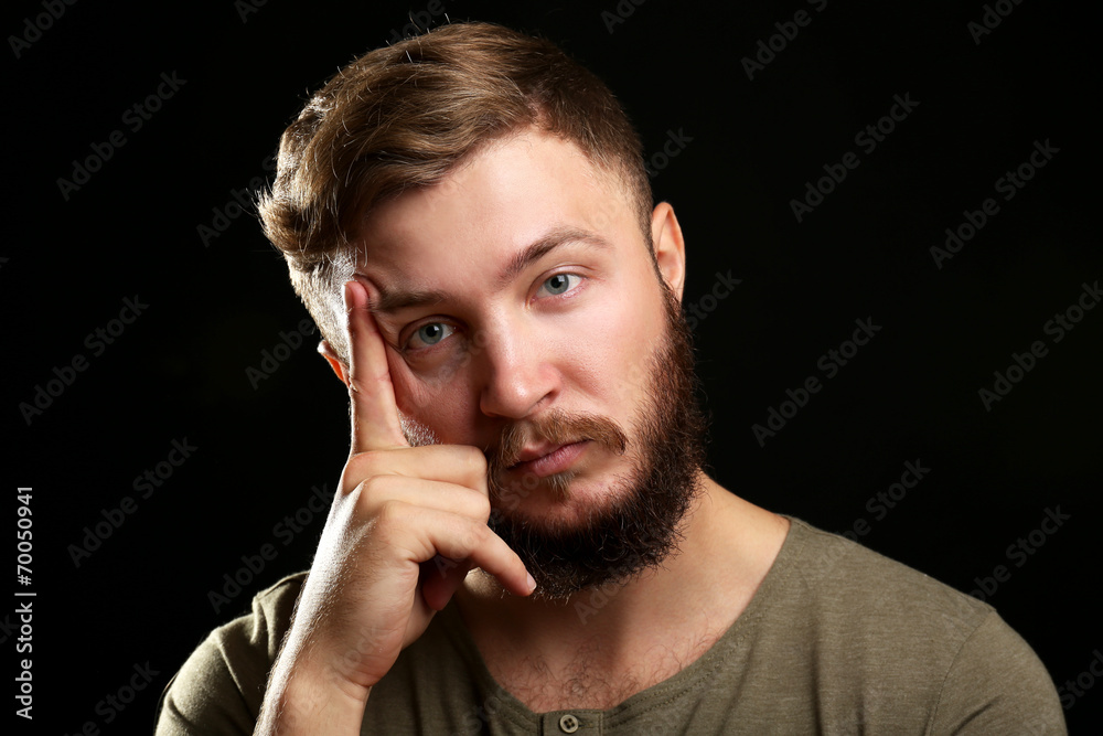Portrait of handsome man with beard on black background Portrait of handsome man with beard on black background