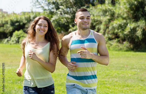 Happy young couple running outdoor