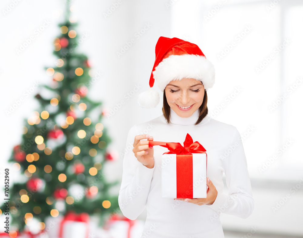 smiling woman in santa helper hat with gift box smiling woman in santa helper hat with gift box