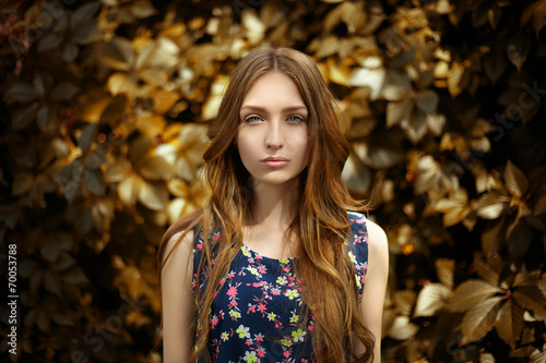 Woman with colorful leaves in beautiful yellow