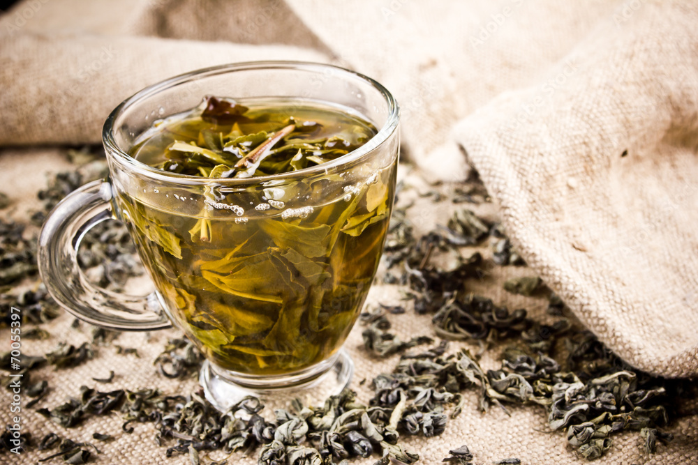 Green tea in transparent glass on linen fabric. Green tea in transparent glass on linen fabric.