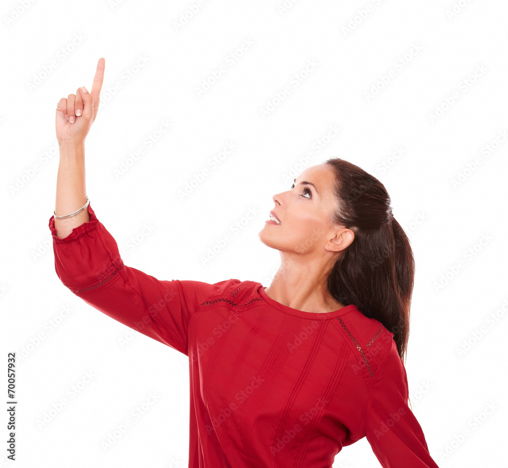 Pretty hispanic woman pointing up and looking up