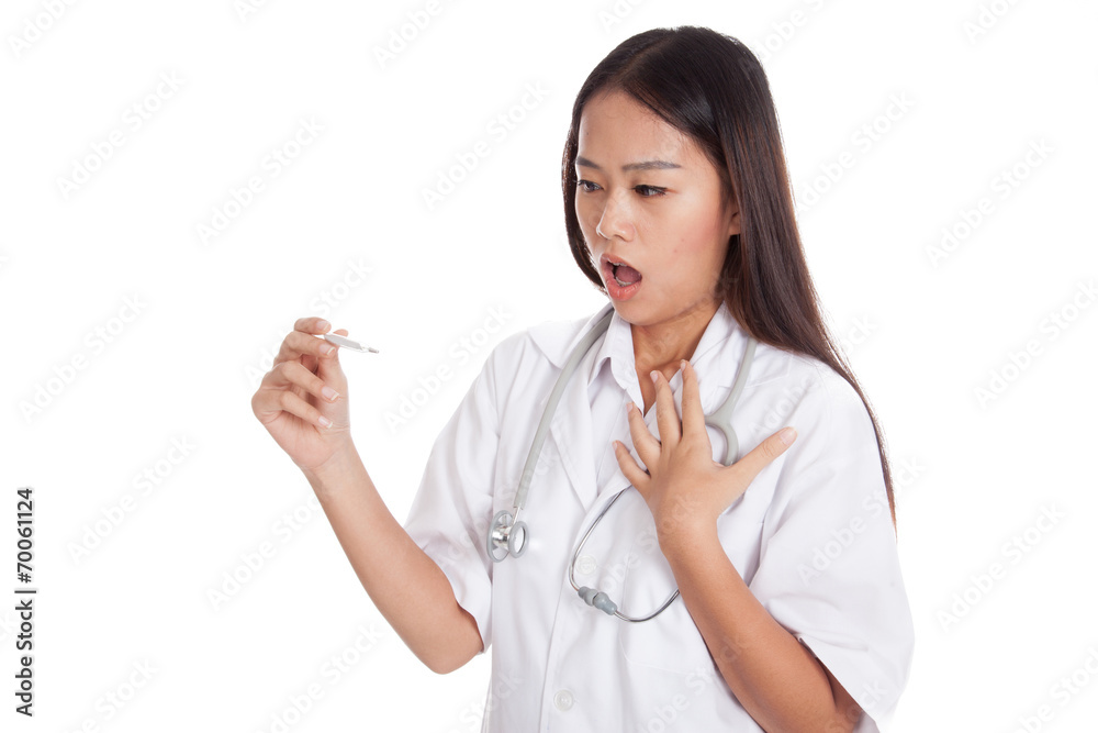 Young Asian female doctor worry look at thermometer Young Asian female doctor worry look at thermometer