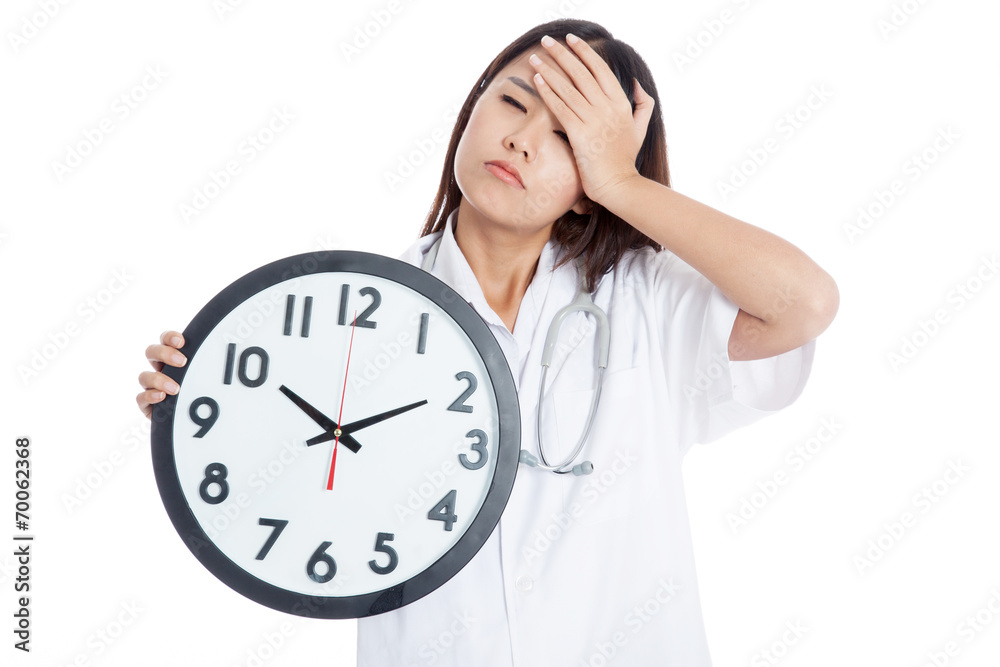 Young Asian female doctor headache with a clock Young Asian female doctor headache with a clock