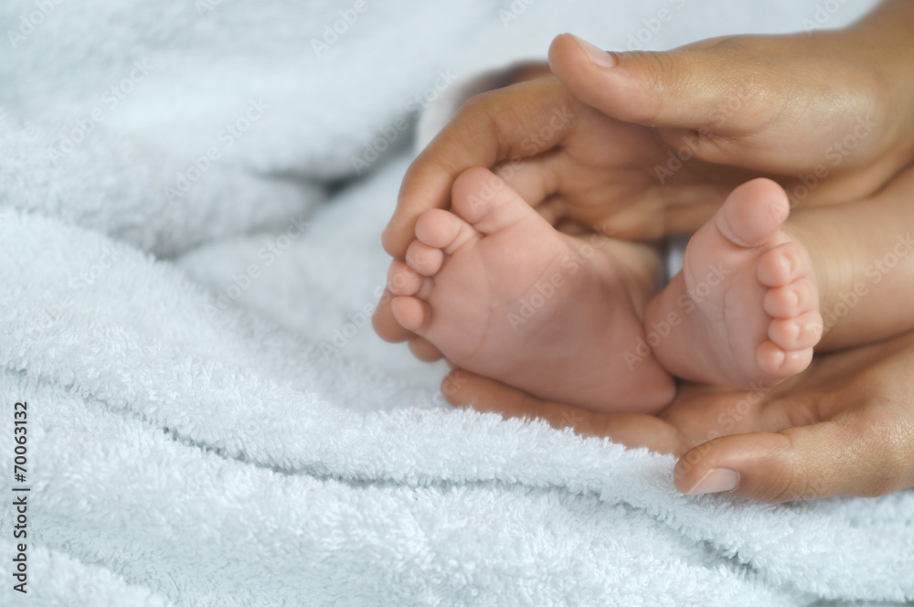 Baby feet in mother's hands Baby feet in mother's hands