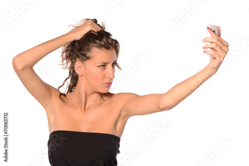 Young woman making selfie on white isolated background