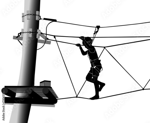 boy in adventure park rope ladder