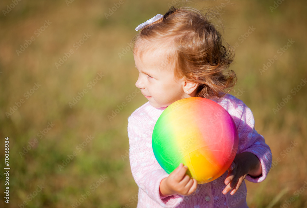 little girl with a ball in park little girl with a ball in park