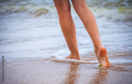 nice legs of a pretty girl walking in water