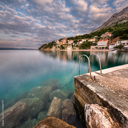 Fototapeta Naklejka Na Ścianę i Meble -  Stone Jetty in Small Village near Omis at Dawn, Dalmatia, Croati