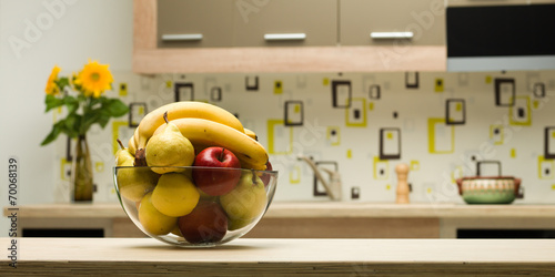 bowl with healthy fruits in kitchen photo