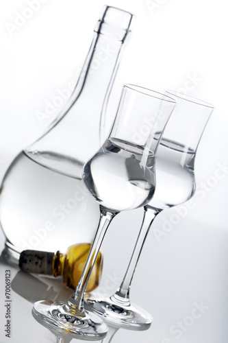 Clear spirit in carafe and glasses