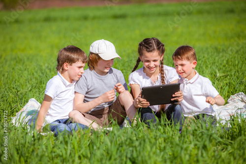 Five friends sitting on grass