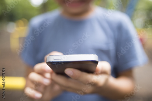 The boy put the phone in the park