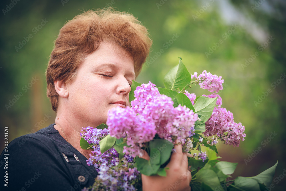 woman in park with a big bouquet of a lilac woman in park with a big bouquet of a lilac