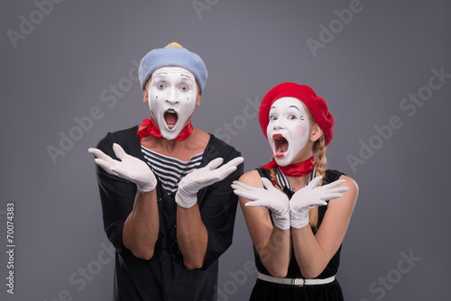 Portrait of funny mime couple with white faces and emotions isol photo