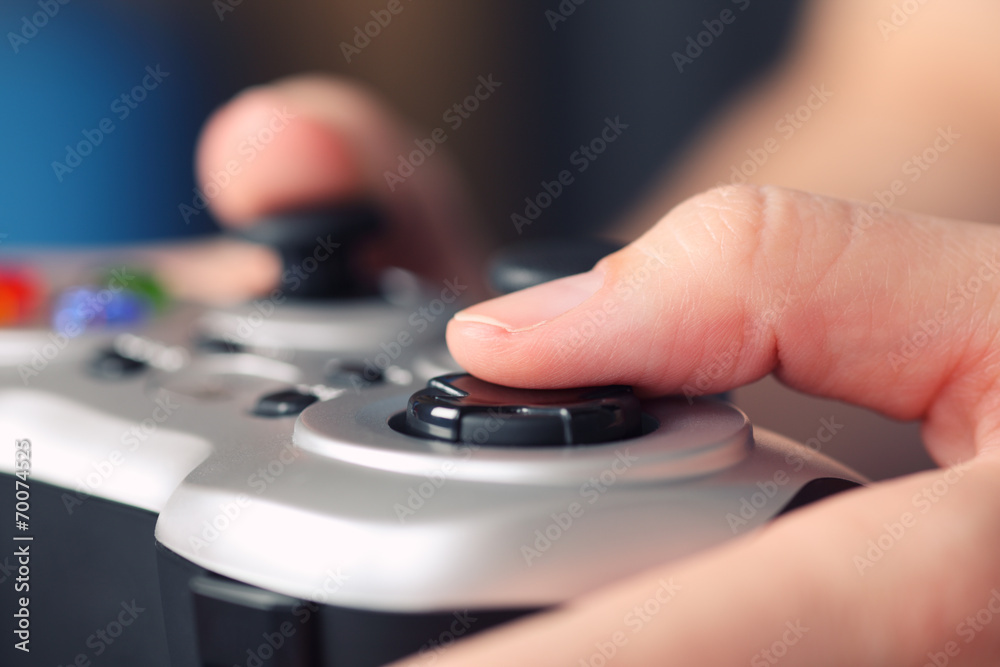 Young woman plays video game using a gamepad Young woman plays video game using a gamepad