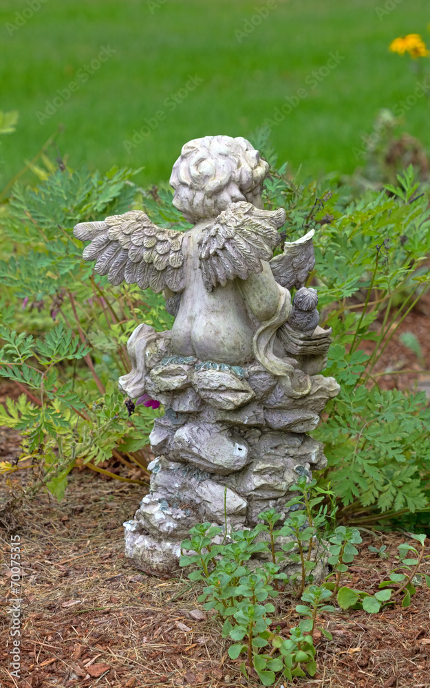 Back of a small garden cherubim with wings