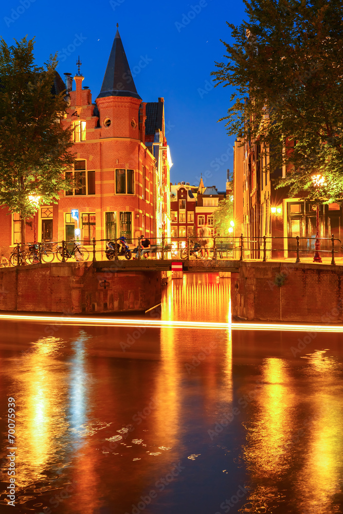 Fototapeta premium Night city view of Amsterdam canal and bridge