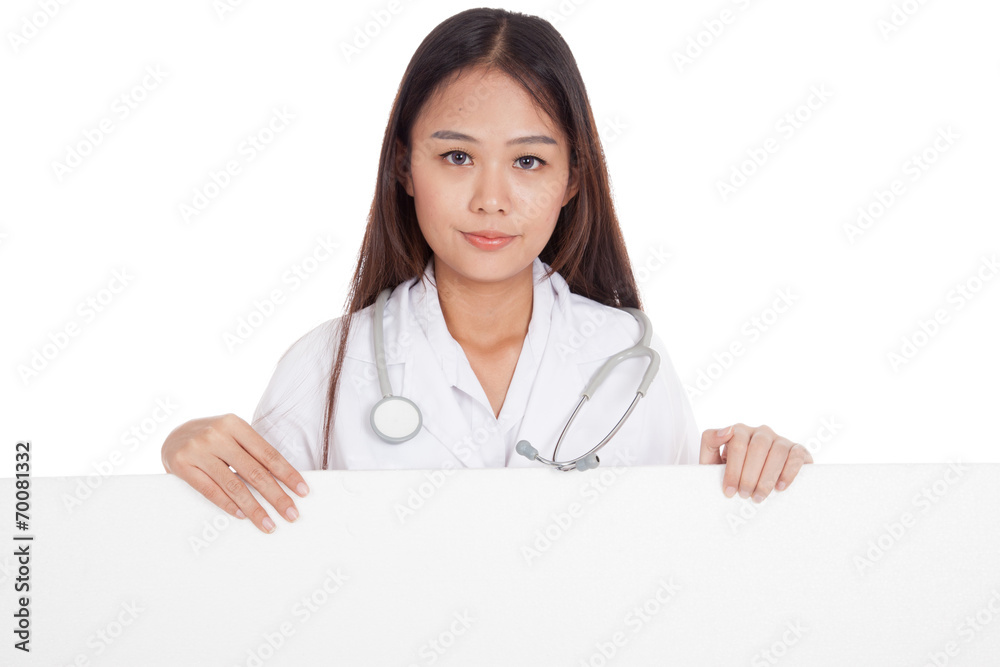 Young Asian female doctor show thumbs up behind blank white bil Young Asian female doctor show thumbs up behind blank white bil