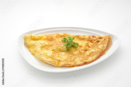 Omelet with celery leaves on white plate