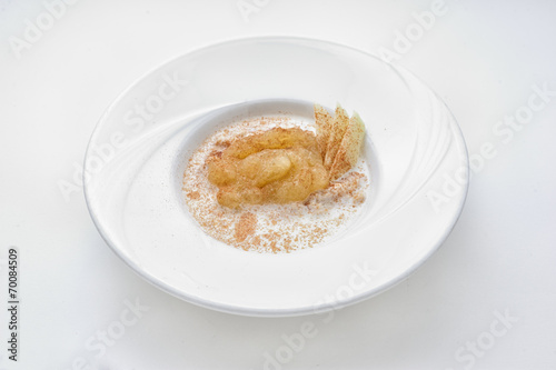 Oatmeal with milk and apple jam in a white plate