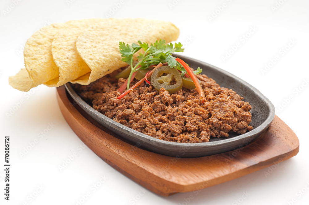 Fried minced lamb meat with loaf on a hot plate Fried minced lamb meat with loaf on a hot plate