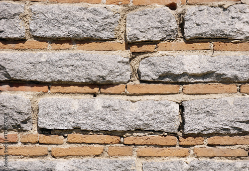 Old stone wall with bricks closeup