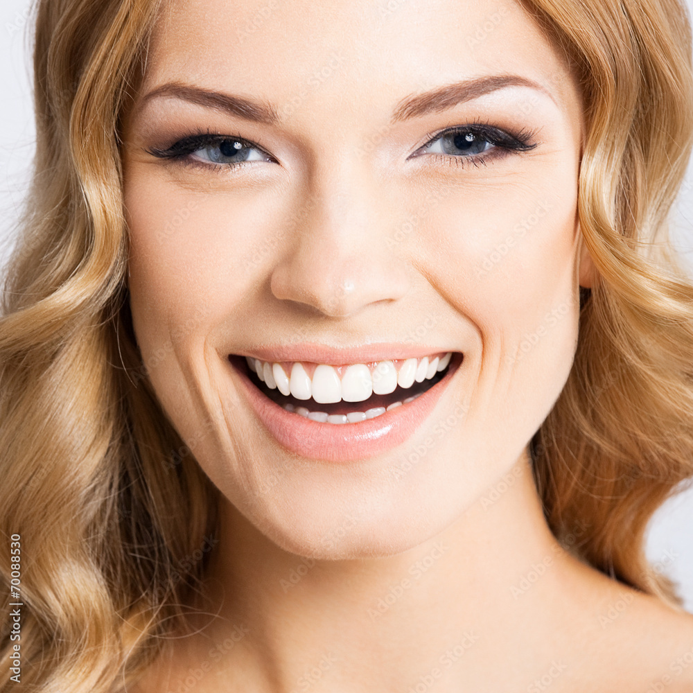Young cheerful smiling woman, on gray Young cheerful smiling woman, on gray