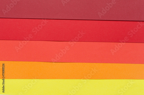warm-colored construction paper sheets arranged horizontally